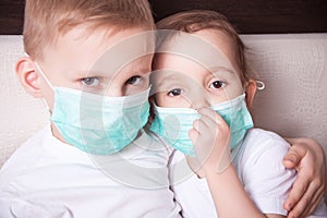 Boy and girl, a children in a medical mask. The concept of an epidemic, influenza, protection from disease, vaccination