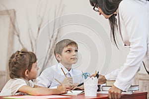 Boy and girl children with the teacher in the school