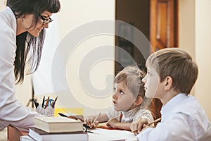 Boy and girl children with the teacher in the school