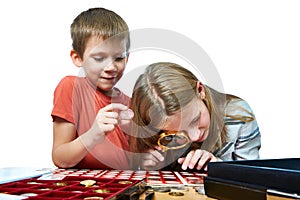 Boy and girl are considering coin collection isolated