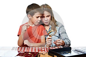 Boy and girl are considering coin collection isolated