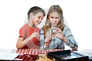 Boy and girl are considering coin collection isolated