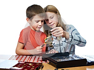 Boy and girl are considering coin collection isolated