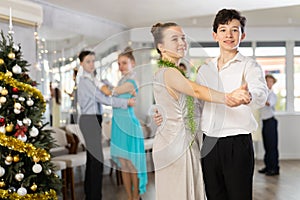 Boy and girl dancing waltz in studio