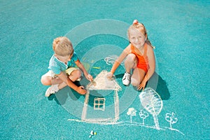 Boy and girl draw chalk image sitting toggether