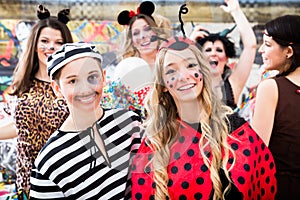 Boy and girl dresses as ladybird and prisoner at German fastnacht carnival procession