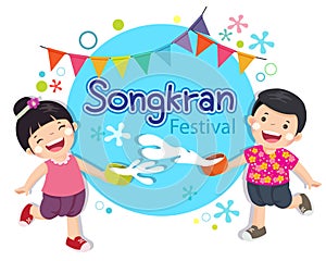 Boy and girl enjoy splashing water in Songkran festival Thailand photo