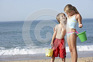 Boy And Girl Enjoying Beach Holiday