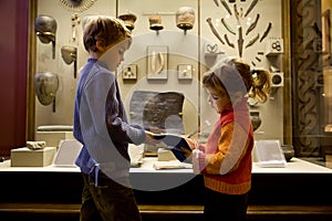 Boy and girl at excursion in historical museum