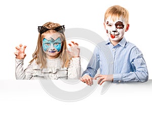 Boy and girl with face art on white background