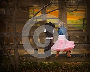 Boy and girl on fence photo