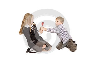 Boy and girl fighting over a lolipop photo