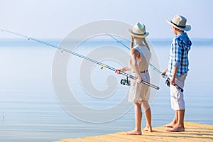 Boy and girl with fishing rods