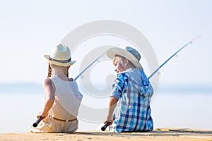 Boy and girl with fishing rods