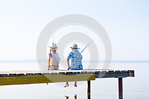 Boy and girl with fishing rods