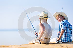 Boy and girl with fishing rods