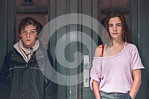 Boy and girl in front of a green door