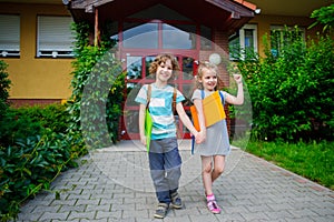 Boy and girl go to school having joined hands.