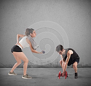 Boy and girl having difficulty at the gym