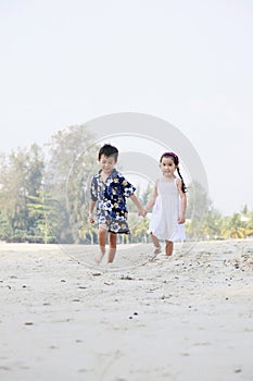 Boy and girl having fun on the beach. Conceptual image