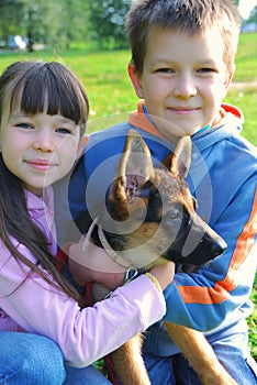 Boy and girl holding dog