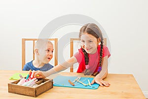 Boy and girl learning to use colorful play dough
