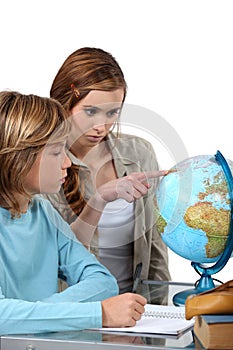 Boy and girl looking at a globe