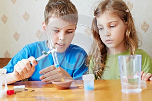 Boy and girl make chemical experiment