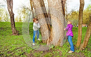 Boy with girl play hide and seek in the forest