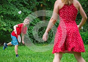 Boy and girl playing badminton