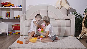 Boy and girl playing colored lego pieces