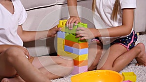 Boy and girl playing colored lego pieces