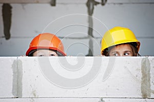 Boy and girl playing on construction site