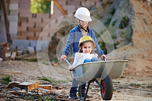 Boy and girl playing on construction site