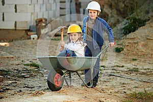 Boy and girl playing on construction site