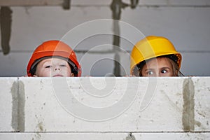 Boy and girl playing on construction site