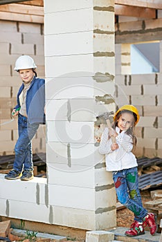 Boy and girl playing on construction site