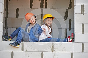 Boy and girl playing on construction site