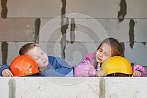 Boy and girl playing on construction site