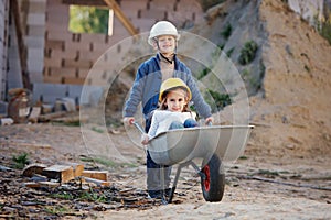 Boy and girl playing on construction site