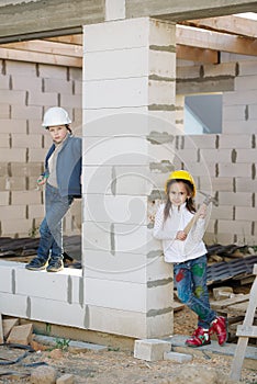 Boy and girl playing on construction site