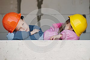 Boy and girl playing on construction site