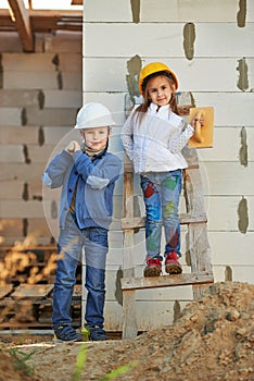Boy and girl playing on construction site