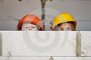 Boy and girl playing on construction site