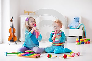 Boy and girl playing flute
