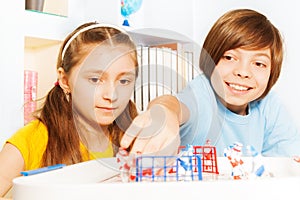 Boy and girl playing ice hockey table board game