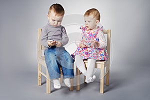 Boy and girl playing with mobile phones