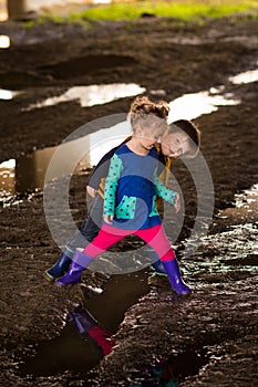 Boy and girl playing in mud