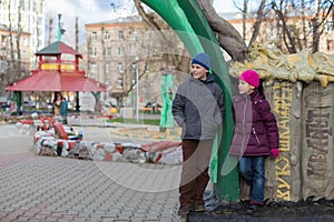 Boy and girl playing in the playground with sculptures