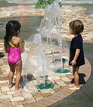 Boy and Girl playing in water pool